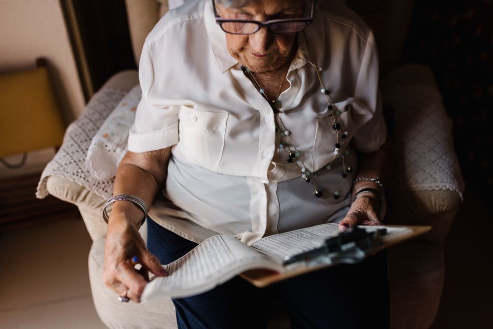 Older woman solving crosswords in apartment