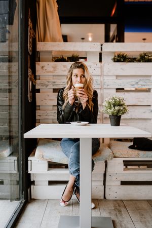 Woman drinking coffee from a glass