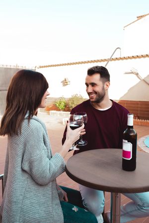 Happy couple drinking wine on terrace