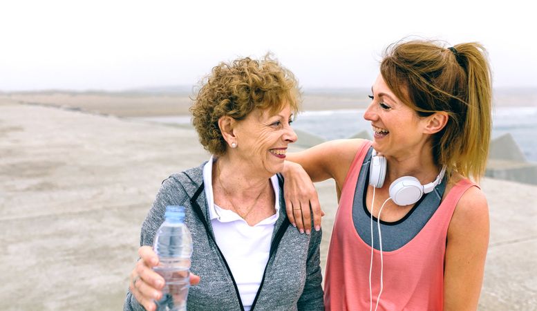 Mature sportswoman laughing with female friend