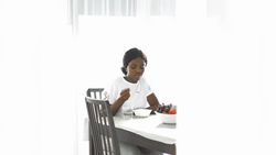 Close-Up of Black Woman Chewing Oats During Breakfast.