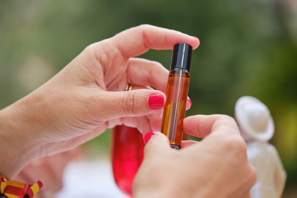Crop woman with bottle of cosmetic oil