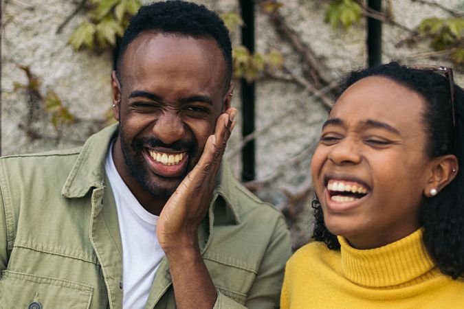two Black people portrait laughing, close-up