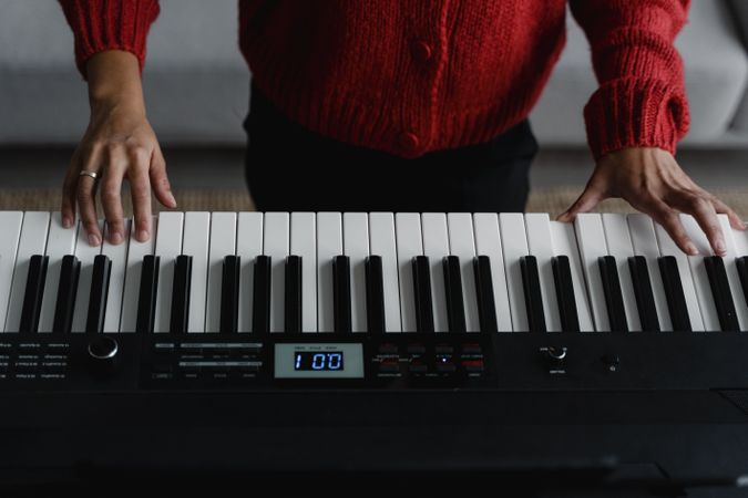 Cropped image of person playing musical keyboard