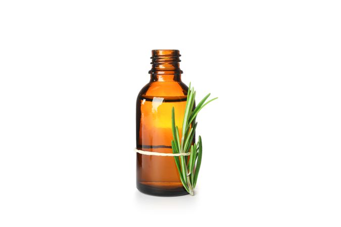 Rosemary oil in jar isolated on neutral background