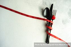 St. Valentine day concept of cutlery wrapped in red ribbon 4mWW6W