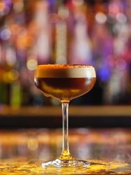 Frothy espresso martini cocktail in bar