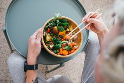 Man with chopsticks eating healthy lunch