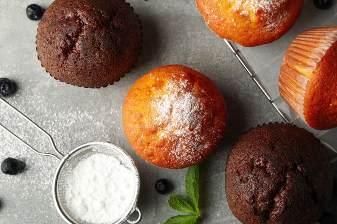 Composition with delicious muffins on gray background