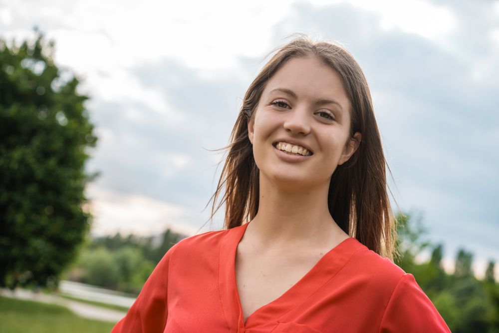 Smiling woman standing in park