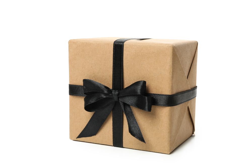 Gift box with dark bow isolated on bright background