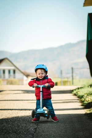 Boy riding on kick scooter