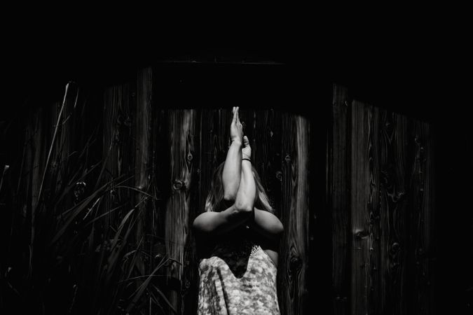 Grayscale photo of woman stretching shoulders