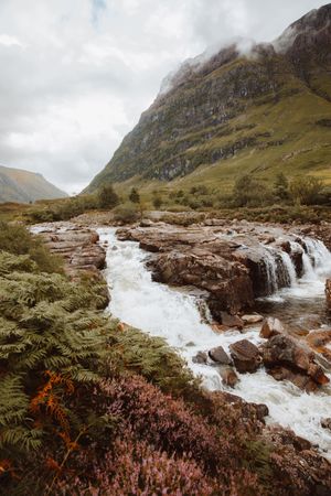 Mountain river with stones on daytime