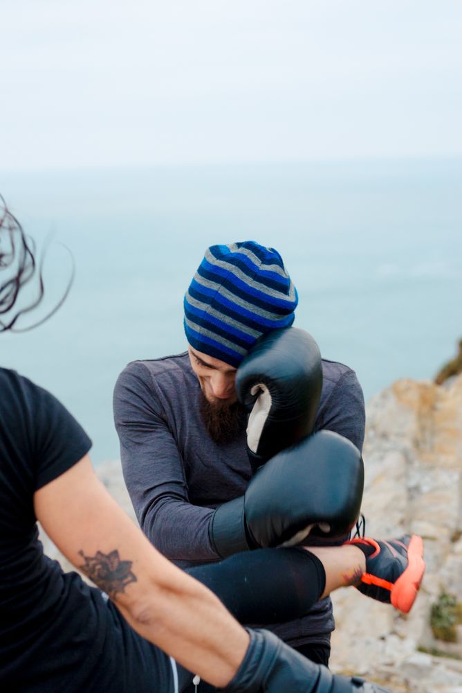 Boxers exercising on cliff