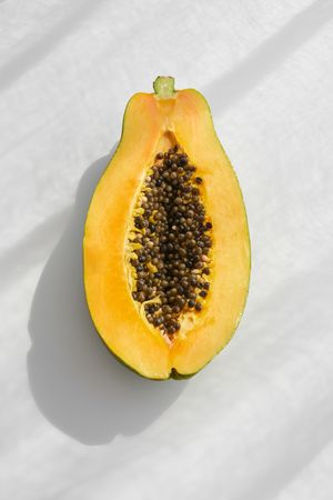 Half of ripe papaya on table