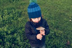 Boy with mushroom in nature