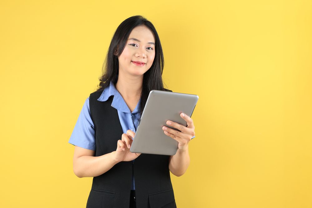 Portrait of Young Asian Woman Company Worker Smiling and Holding Digital Tablet Computer
