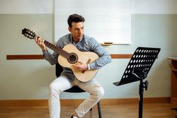 Man playing guitar in studio