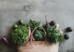 Jute bag with fresh produce, top view, horizontal composition, copy space