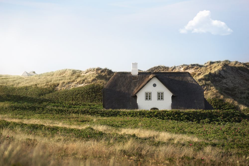 House in the middle of grassy hills