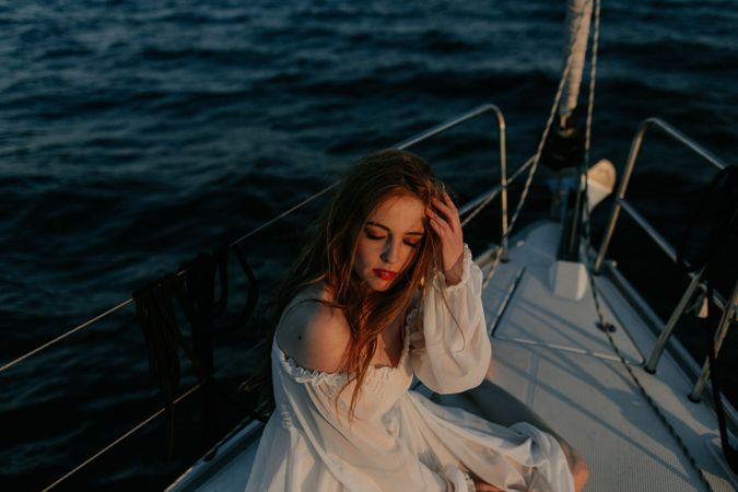 Woman in luxury dress resting on yacht