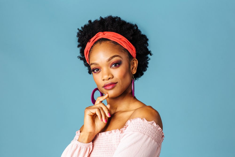 Studio shoot of Black woman with hand on her chin