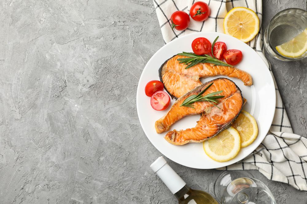 Composition with tasty grilled salmon on gray background, top view