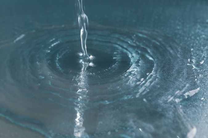 Drop of water on metallic blue surface