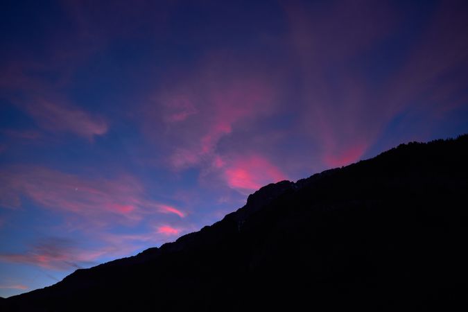 Sunset sky over mountain ridge