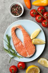 Composition with salmon meat and ingredients on gray background, top view