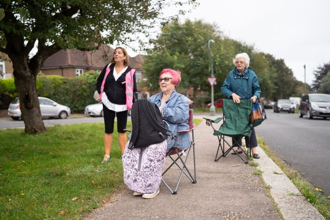 Three woman sitting calmly outside drawing