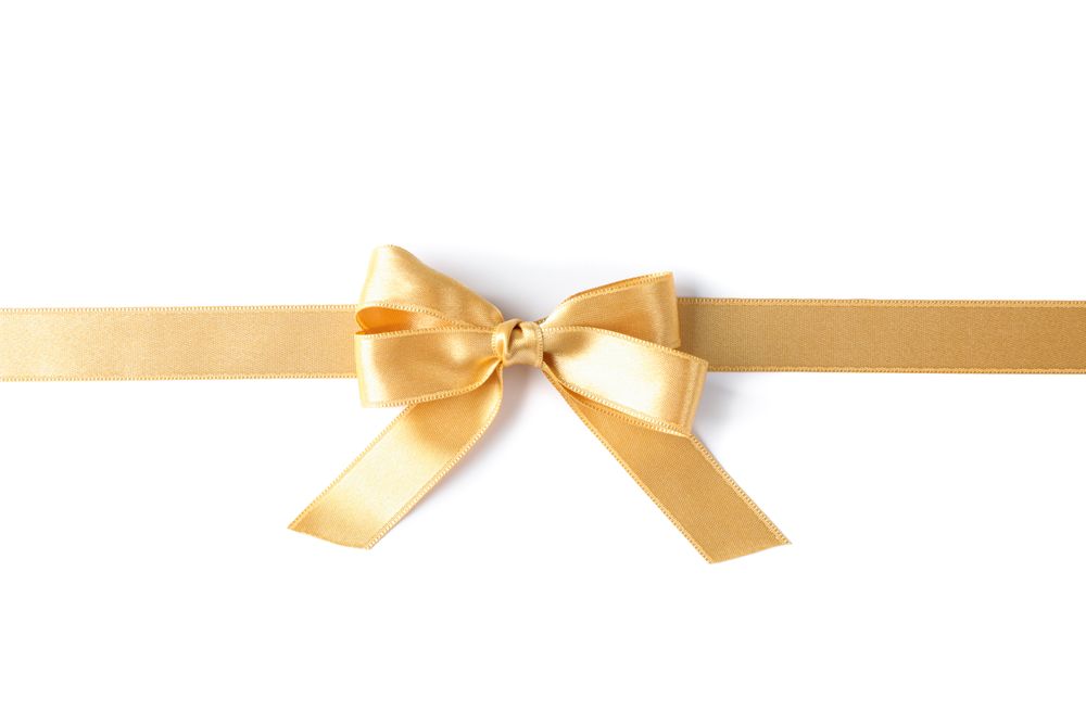 Golden ribbon with bow isolated on plain background. Gift concept