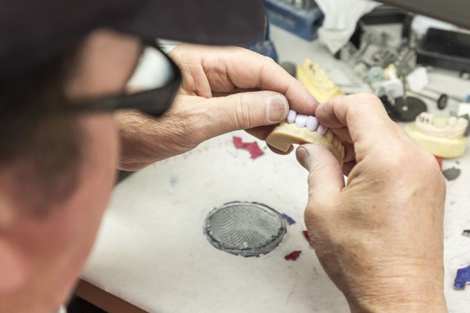 Dental Technician Working On 3D Printed Mold For Tooth Implants