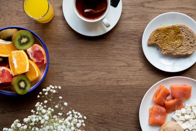 Juice and plate with granola and fruits on table