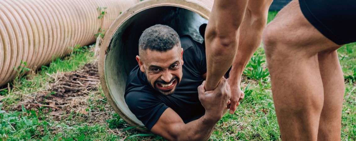 Participants obstacle course going through a pipe