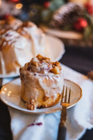 Freshly baked Christmas bun on dessert plate with fork