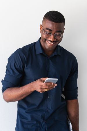 Happy Black guy with phone and laptop