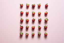 Fresh strawberries symmetrically aligned on the table