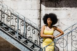 Stylish female leaning on railing outdoors