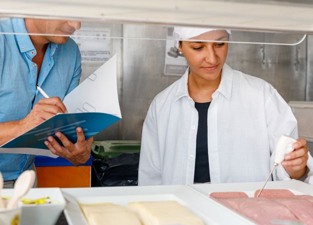Colleagues checking food quality in canteen