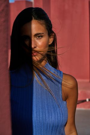 Woman looking at camera in sunlight