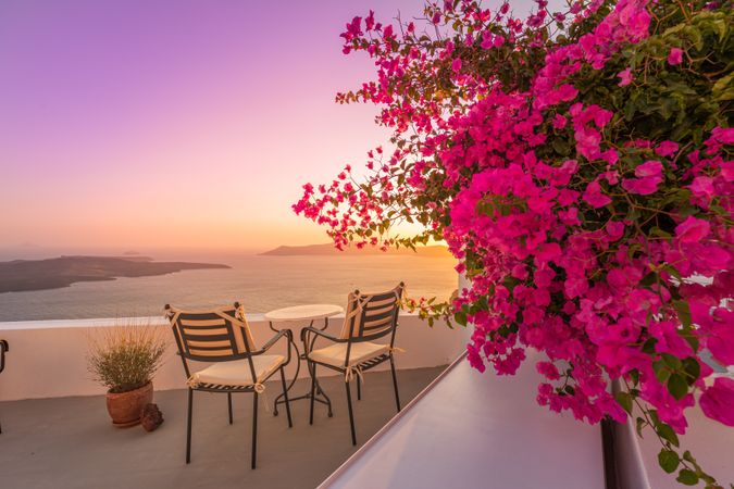 Rooftop with seats looking out over Aegean Sea with pink bougainvillea flowers