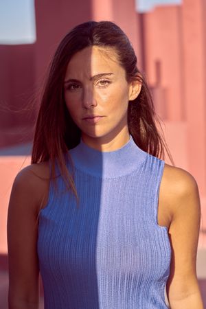 Woman looking at camera in sunlight