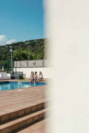 Group of friends sunbathing by the pool