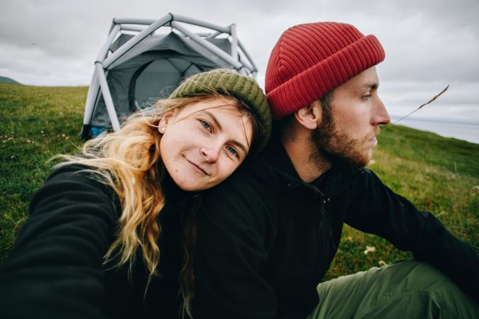 Man and woman pictured in front of tent