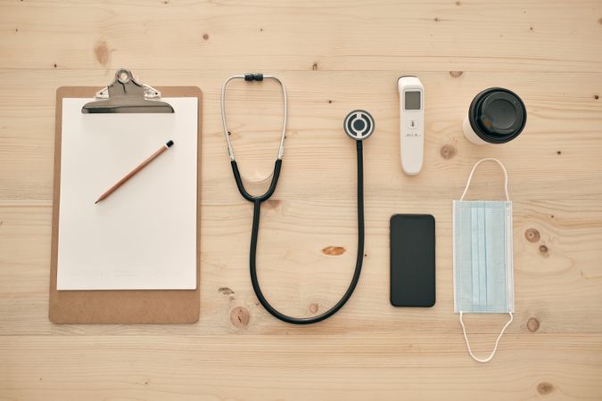 Medical mask and instruments with clipboard and coffee to go