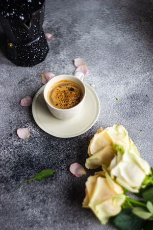 Floral card on concrete background with cup of coffee