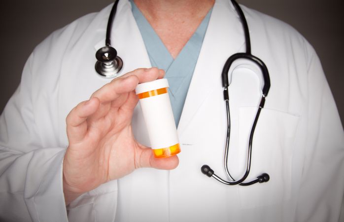 Male Doctor with Blank Medicine Bottle