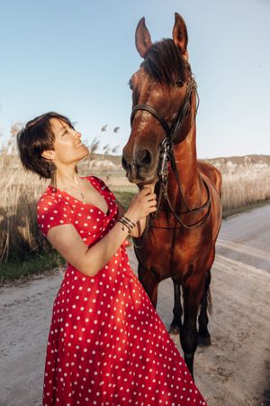 Young woman with horse on ranch